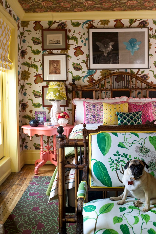 This is an example of a traditional bedroom in New York with multi-coloured walls and medium hardwood floors.