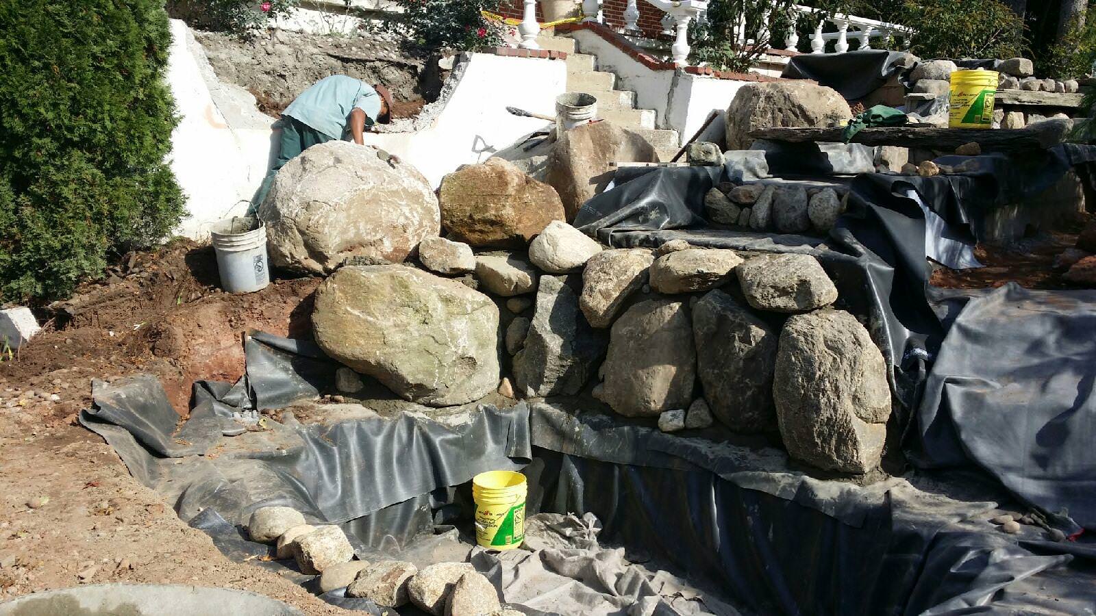 waterfall stream with stone bridge and natural bluestone walkwayway and steps