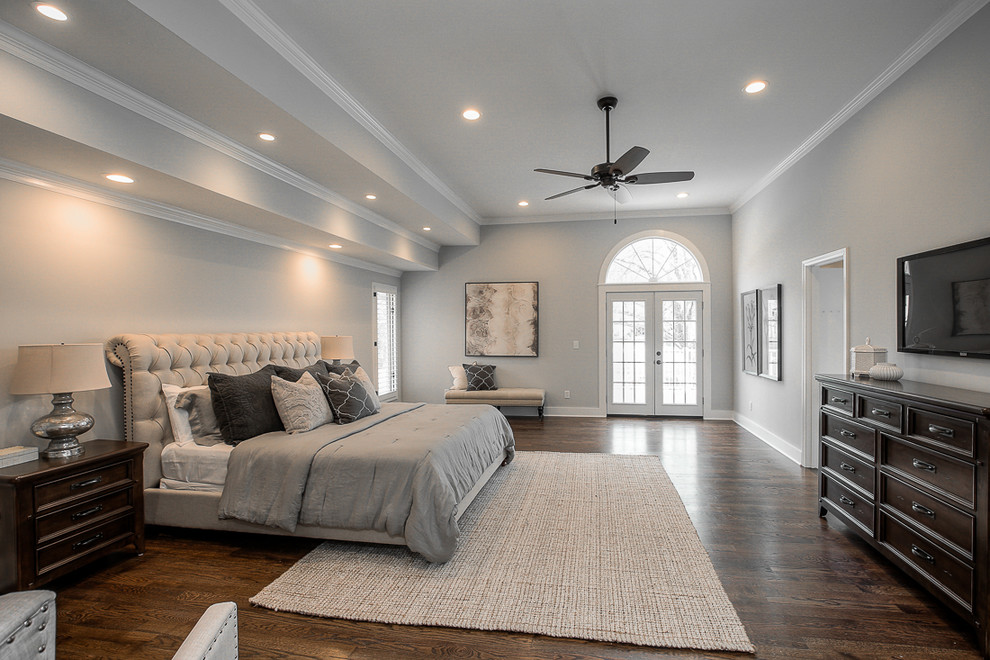 Photo of a traditional bedroom in Kansas City with grey walls, dark hardwood floors and brown floor.