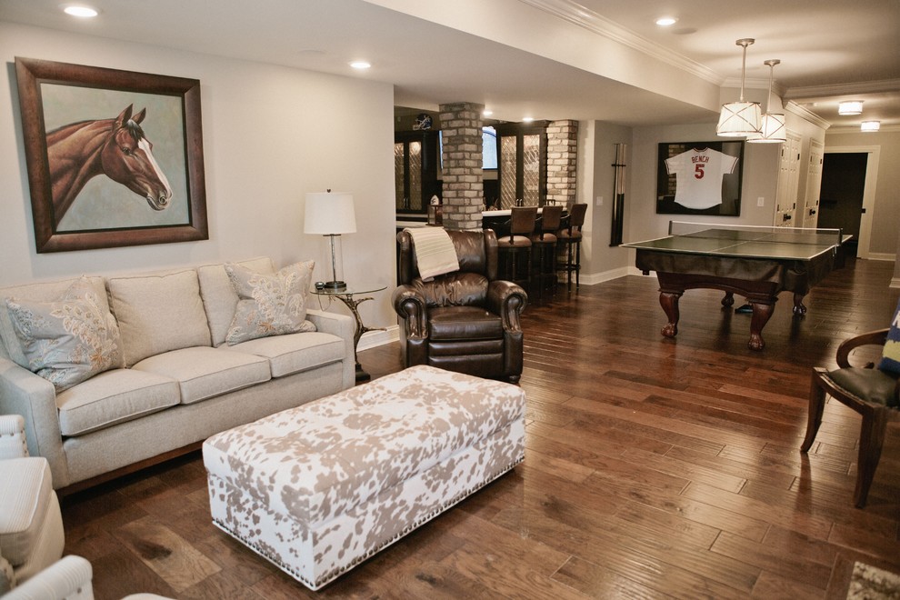 Expansive traditional look-out basement in Other with beige walls and dark hardwood floors.