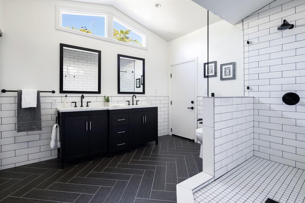 Design ideas for a mid-sized midcentury master bathroom in Orange County with flat-panel cabinets, black cabinets, an open shower, a two-piece toilet, white tile, ceramic tile, white walls, porcelain floors, an undermount sink, engineered quartz benchtops, black floor and an open shower.