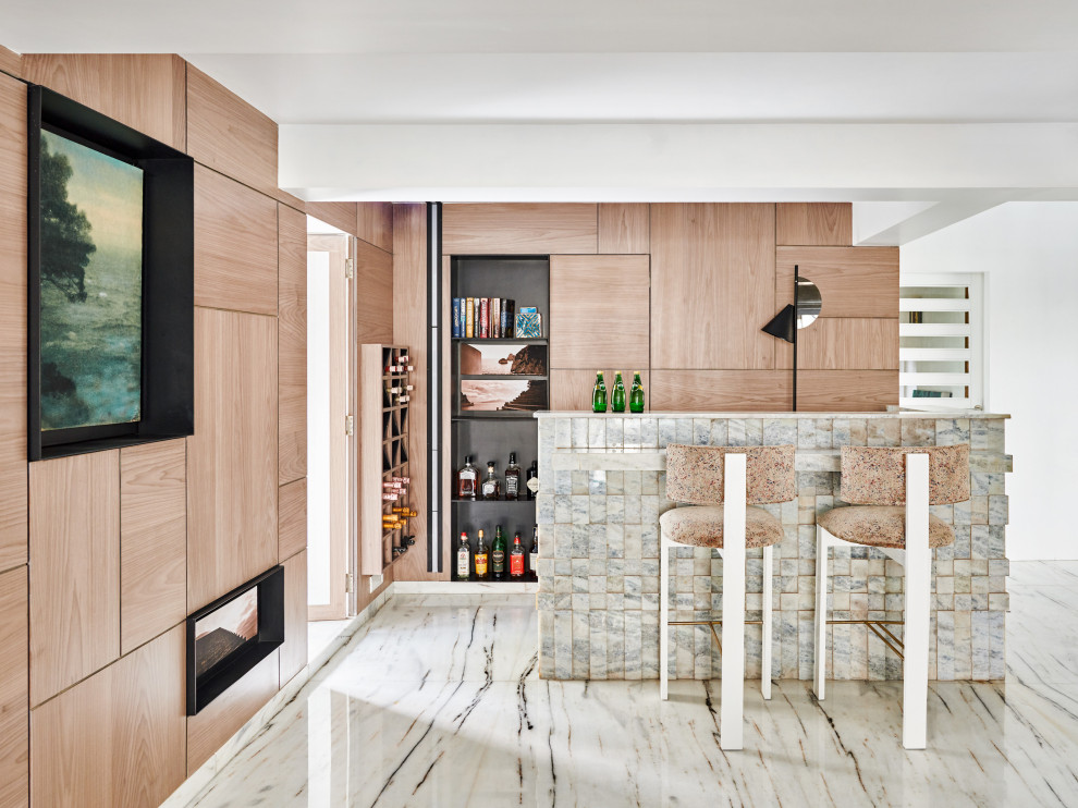 Mid-sized contemporary l-shaped seated home bar in Mumbai with flat-panel cabinets, medium wood cabinets, grey floor and grey benchtop.