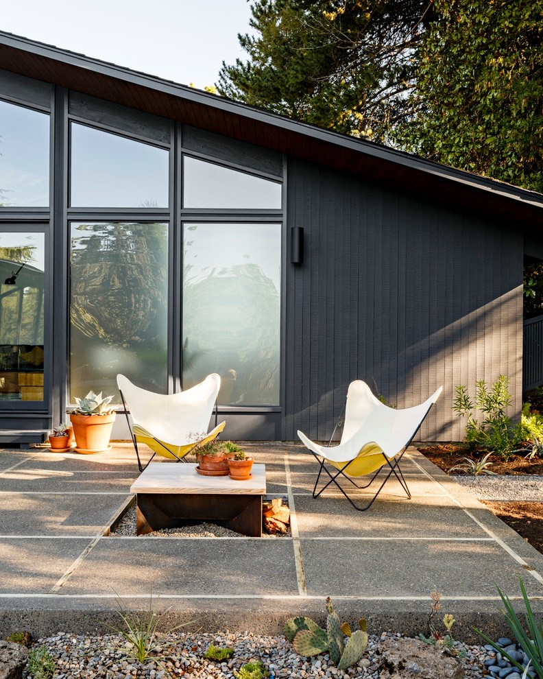 Photo of a midcentury patio in Portland with a fire feature and no cover.