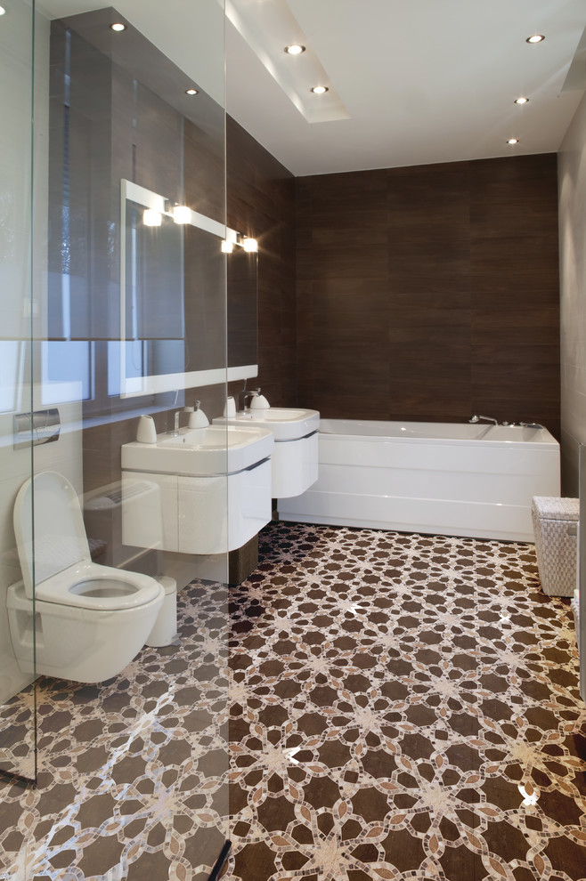 Design ideas for a contemporary bathroom in Chicago with a wall-mount sink, white cabinets, a freestanding tub, a corner shower, a wall-mount toilet, brown tile and brown walls.