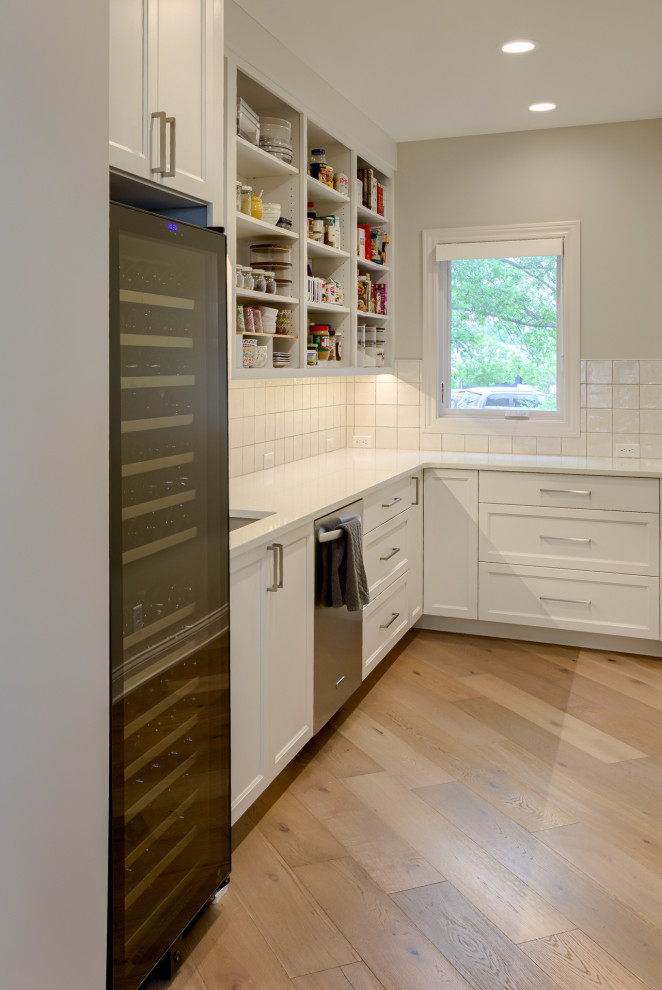 Inspiration for a large transitional light wood floor kitchen pantry remodel with a single-bowl sink, recessed-panel cabinets, white cabinets, quartzite countertops, stainless steel appliances and an island