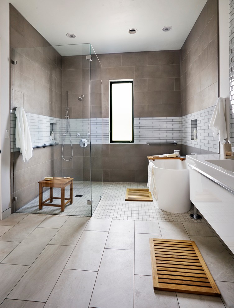 Inspiration for a contemporary master bathroom in Portland with a console sink, a freestanding tub, a curbless shower, brown tile and brown walls.