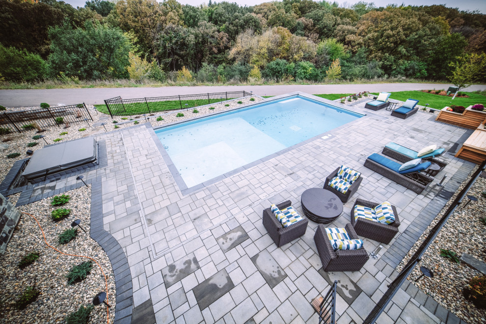 Inspiration for a large transitional backyard concrete paver and rectangular hot tub remodel