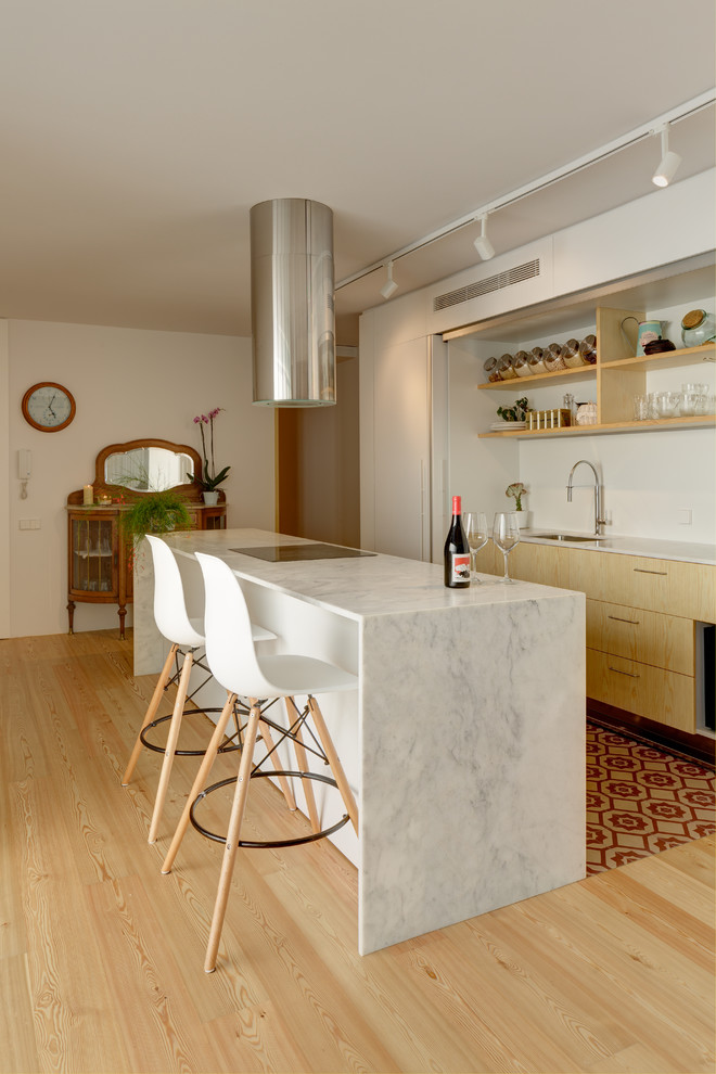 This is an example of a contemporary open plan kitchen in Alicante-Costa Blanca with an undermount sink, flat-panel cabinets, white cabinets, marble benchtops, light hardwood floors, with island and white benchtop.