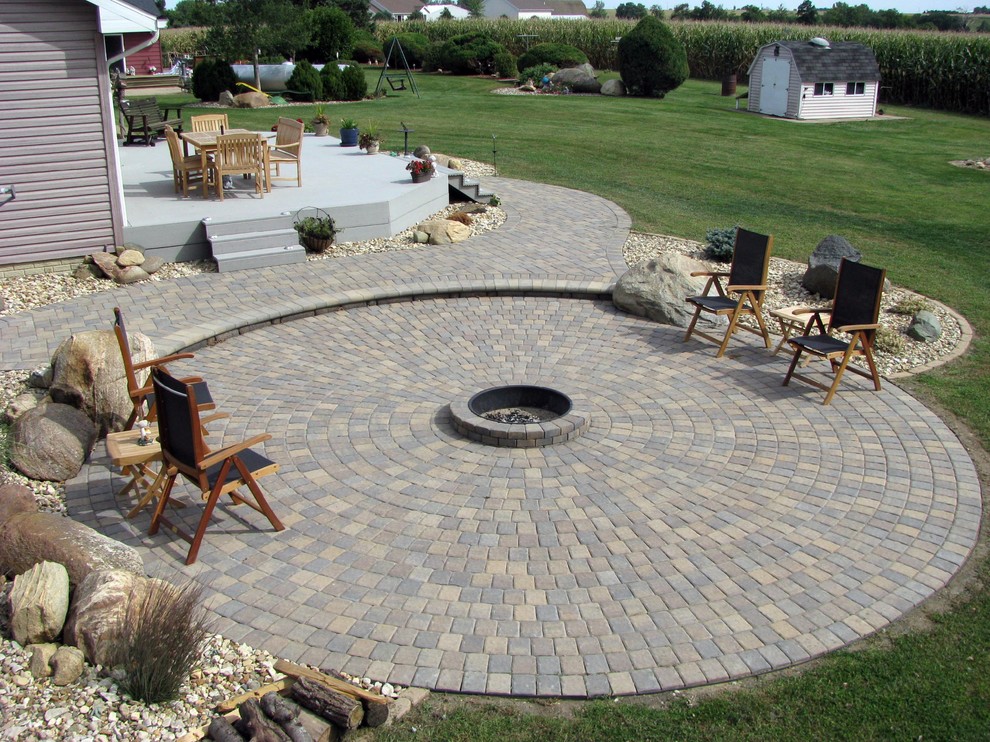 Mid-sized traditional backyard patio in Cedar Rapids with natural stone pavers and no cover.