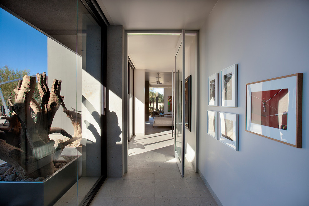 This is an example of an expansive contemporary hallway in Phoenix with white walls.