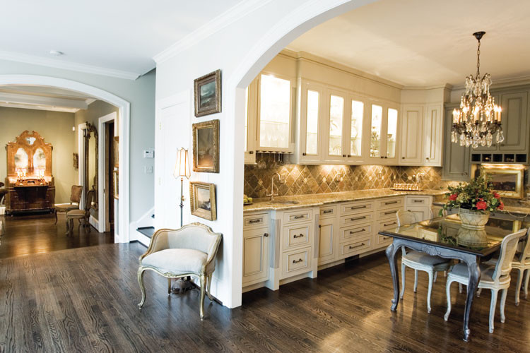 Inspiration for a large transitional l-shaped dark wood floor eat-in kitchen remodel with a double-bowl sink, distressed cabinets, quartz countertops, brown backsplash, ceramic backsplash, stainless steel appliances and an island
