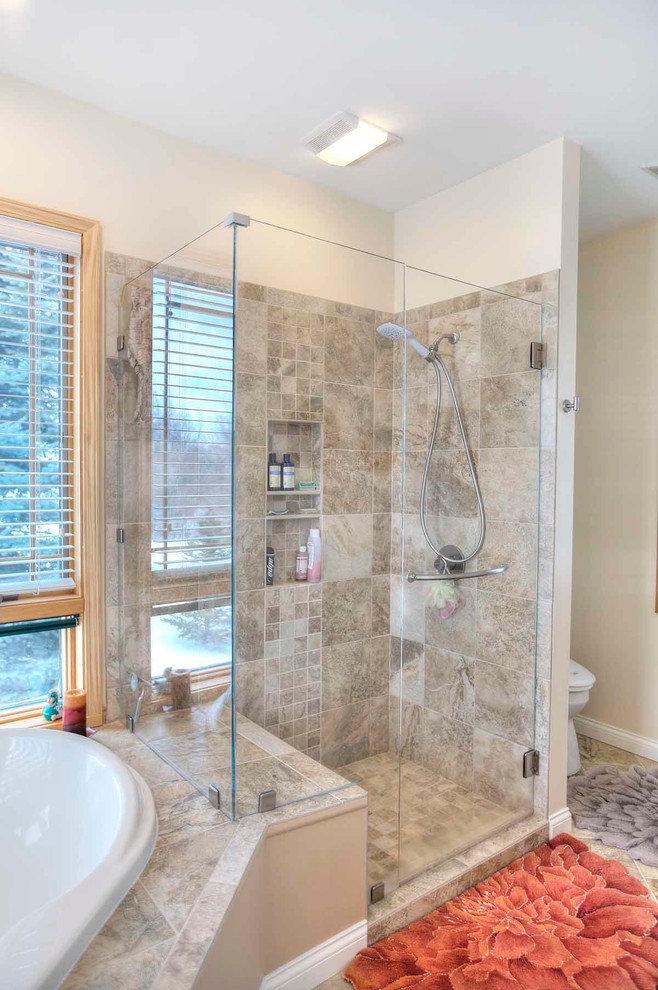 Example of a mid-sized transitional master brown tile and porcelain tile slate floor drop-in bathtub design with flat-panel cabinets, medium tone wood cabinets and quartz countertops
