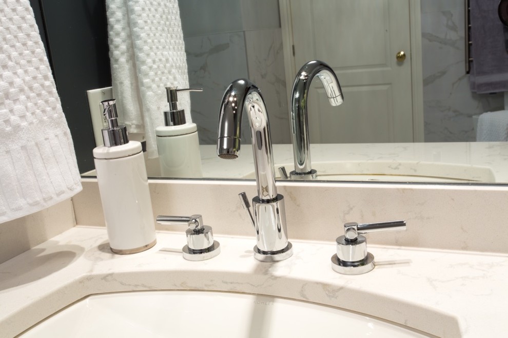 Inspiration for a large transitional master gray tile, white tile and stone tile marble floor home design remodel in Toronto with shaker cabinets, blue cabinets, a one-piece toilet, white walls, an undermount sink and solid surface countertops