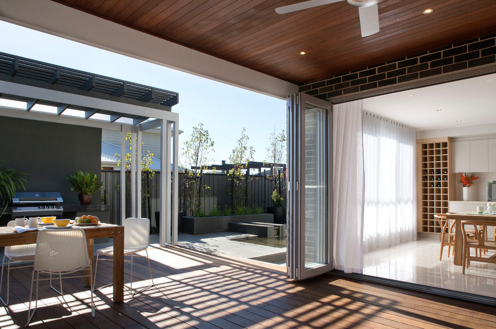 This is an example of a contemporary deck in Melbourne with a pergola.