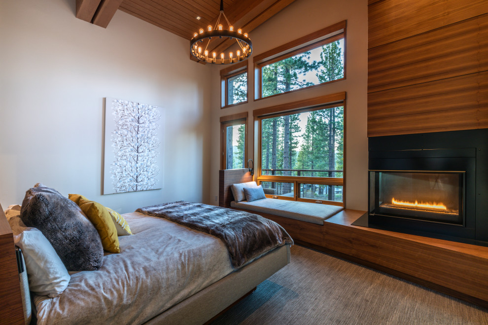 Diseño de dormitorio principal minimalista de tamaño medio con paredes blancas, moqueta, todas las chimeneas, marco de chimenea de madera, suelo gris y madera