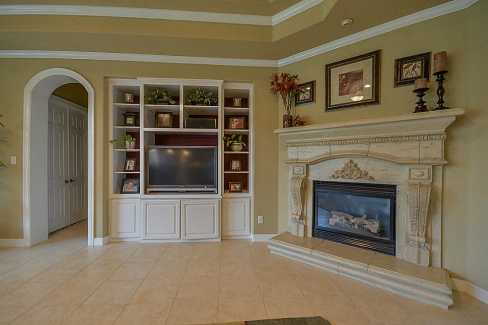 Small transitional home design photo in Houston with a standard fireplace and a stone fireplace