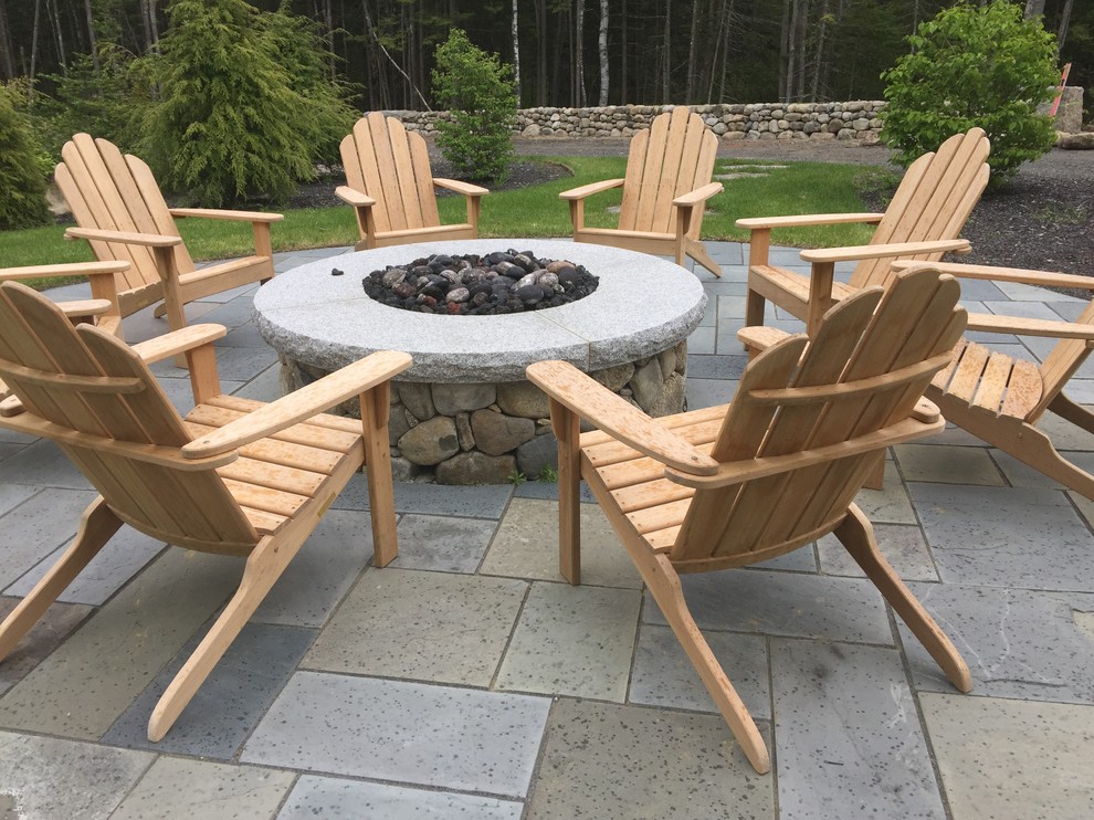 This is an example of a mid-sized traditional backyard patio in Portland Maine with a fire feature and natural stone pavers.