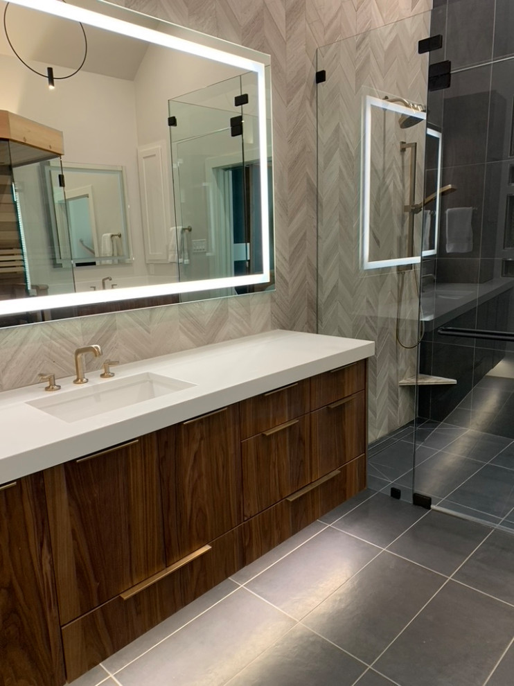 Photo of a modern ensuite bathroom in Dallas with flat-panel cabinets, dark wood cabinets, a corner shower, white tiles, porcelain tiles, porcelain flooring, a submerged sink, engineered stone worktops, grey floors, a hinged door, white worktops, double sinks and a floating vanity unit.