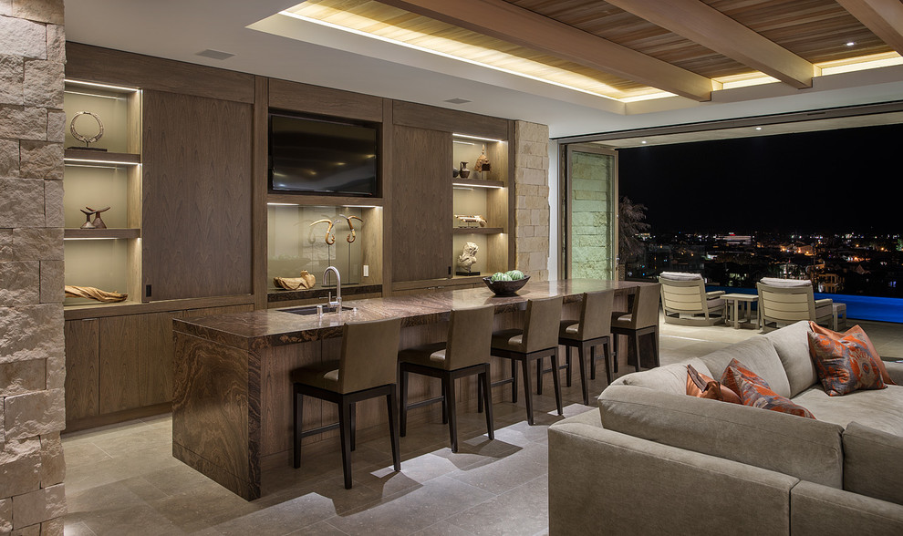This is an example of a contemporary seated home bar in Los Angeles with an undermount sink, flat-panel cabinets, dark wood cabinets and brown benchtop.