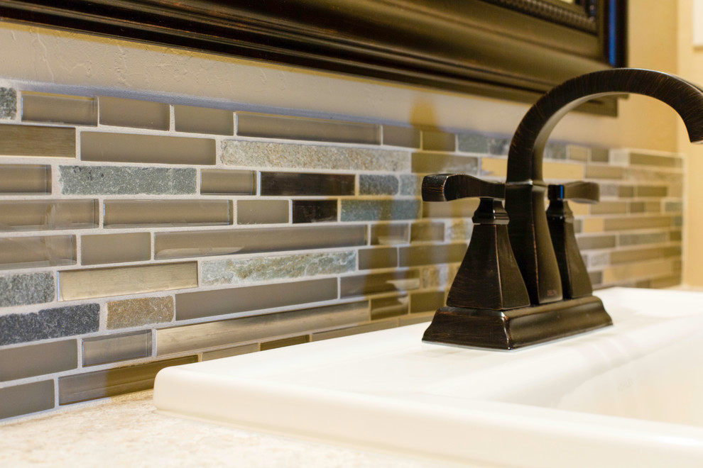 Example of a mid-sized transitional multicolored tile and ceramic tile bathroom design with beige walls and a drop-in sink
