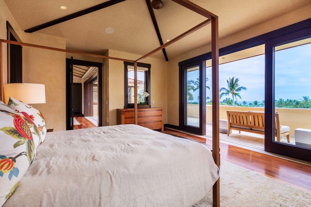 Inspiration for a large tropical guest bedroom in Hawaii with dark hardwood floors.