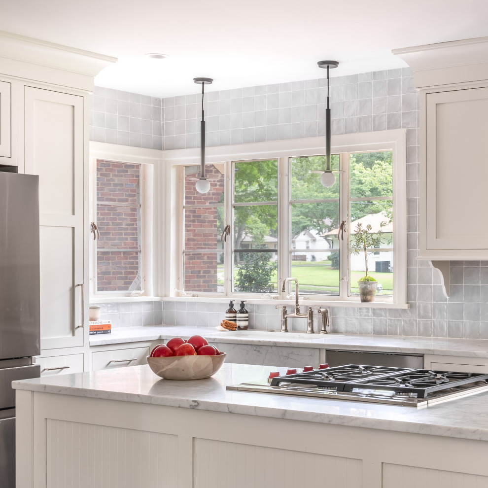 Example of a mid-sized transitional l-shaped cement tile floor and gray floor eat-in kitchen design with a drop-in sink, shaker cabinets, white cabinets, quartzite countertops, gray backsplash, porcelain backsplash, stainless steel appliances, an island and multicolored countertops