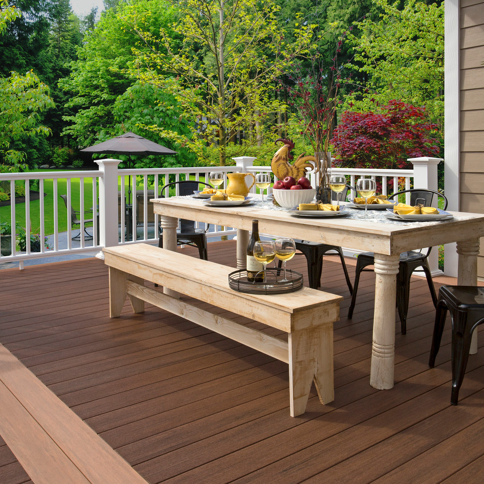 Photo of a large traditional backyard deck in New York with a pergola.