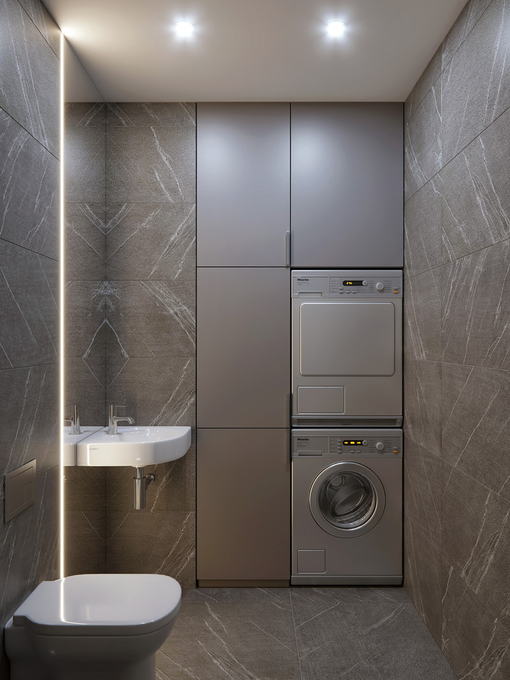Design ideas for a small contemporary powder room in Valencia with a wall-mount toilet, gray tile, porcelain tile, porcelain floors, a wall-mount sink, grey floor, flat-panel cabinets, grey cabinets and grey walls.