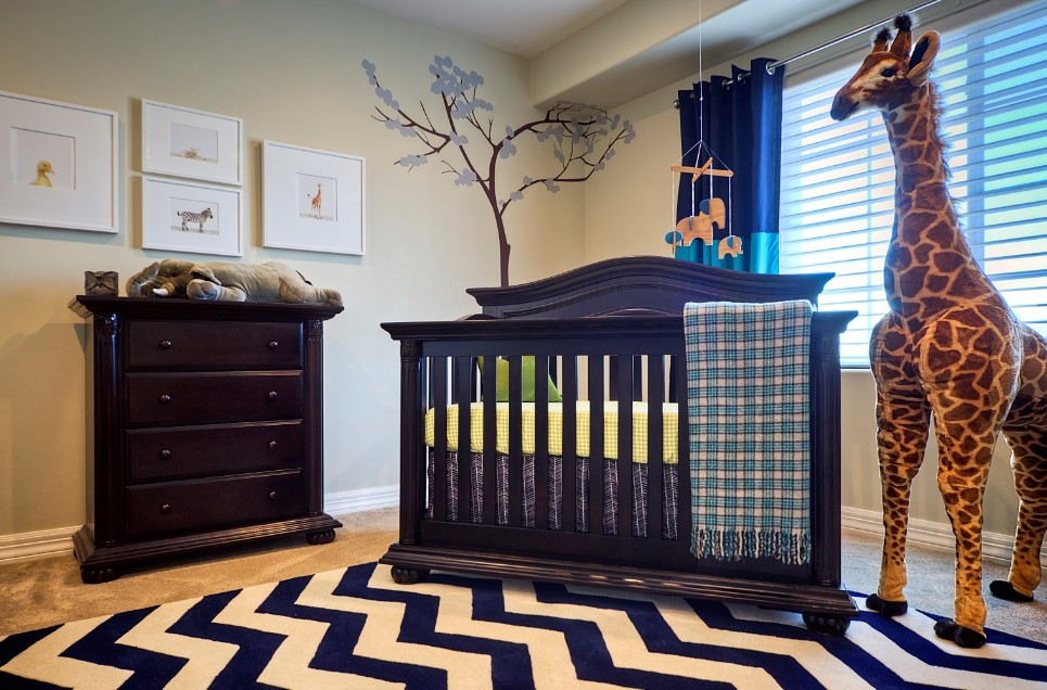 Photo of a transitional nursery for boys in Orange County with beige walls and carpet.