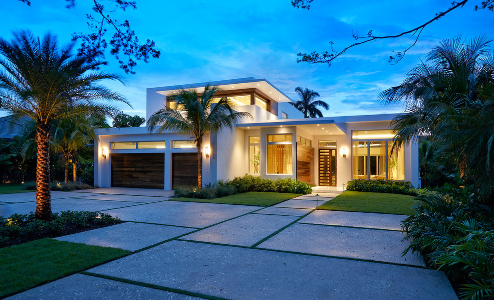 Large modern two-storey stucco white house exterior in Miami with a flat roof and a green roof.