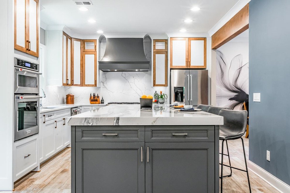 Photo of a large midcentury eat-in kitchen in Other with a drop-in sink, shaker cabinets, white cabinets, quartz benchtops, white splashback, stainless steel appliances, ceramic floors, with island, beige floor and white benchtop.