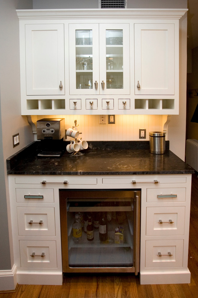 Photo of a traditional kitchen in DC Metro with white splashback, bamboo floors and brown floor.