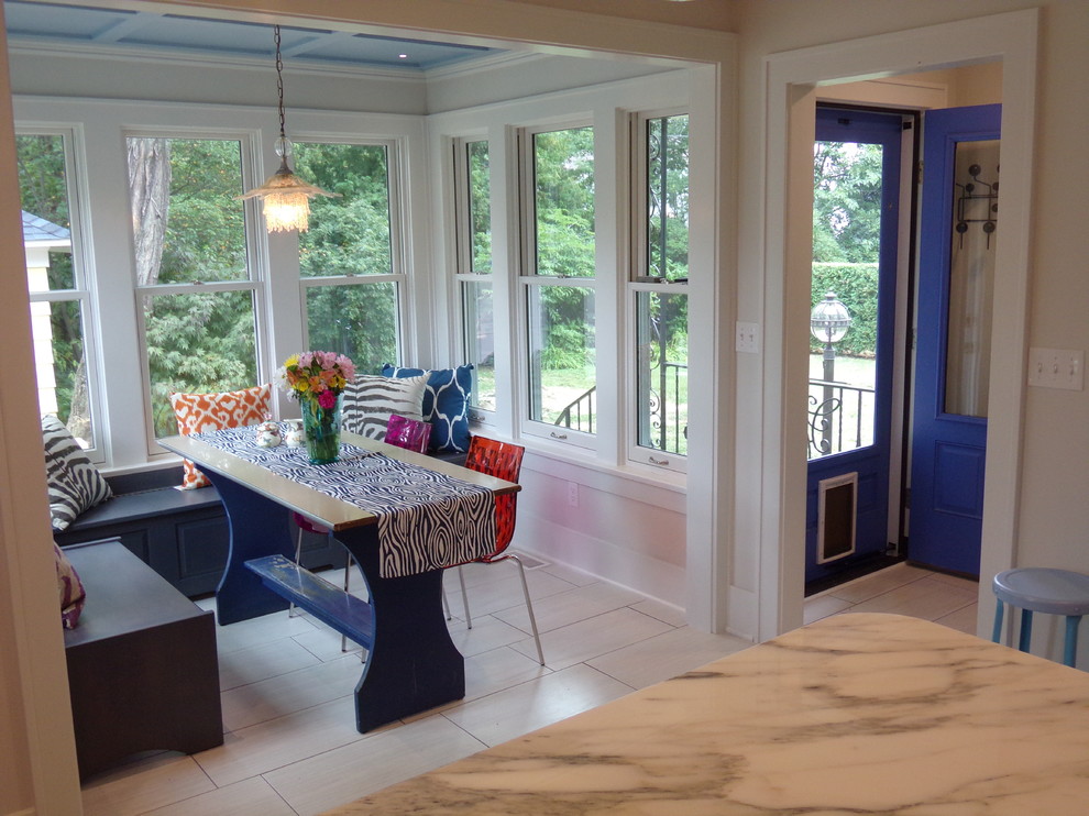 Example of a large transitional u-shaped porcelain tile eat-in kitchen design with a farmhouse sink, flat-panel cabinets, gray cabinets, marble countertops, white backsplash, ceramic backsplash, white appliances and no island