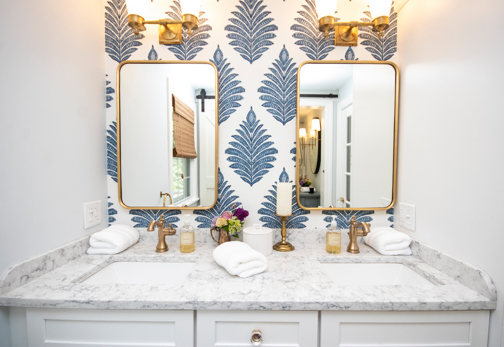 This is an example of a mid-sized traditional master bathroom in Providence with recessed-panel cabinets, white cabinets, a drop-in tub, a shower/bathtub combo, a one-piece toilet, white tile, subway tile, blue walls, porcelain floors, an undermount sink, granite benchtops, white floor, a hinged shower door and white benchtops.