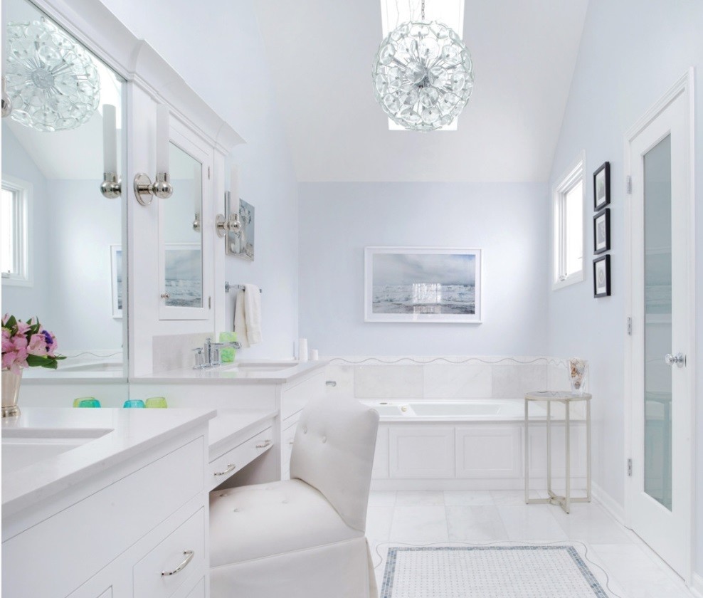Inspiration for a mid-sized beach style master bathroom in New York with a drop-in sink, flat-panel cabinets, onyx benchtops, an undermount tub, a curbless shower, blue tile, cement tile, black walls, marble floors and white cabinets.