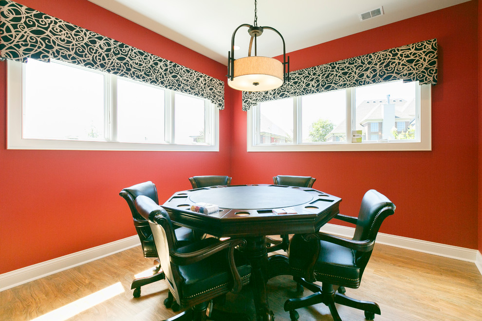Mid-sized traditional dining room in Louisville with red walls and light hardwood floors.