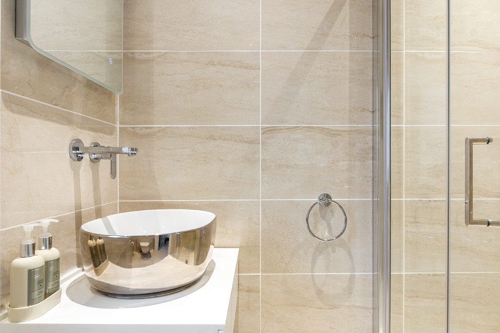 Inspiration for a modern bathroom in London with porcelain tile and a vessel sink.