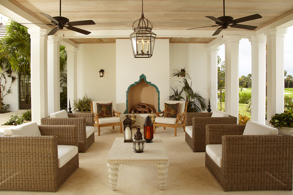 Photo of a mediterranean courtyard patio in Miami with a fire feature.