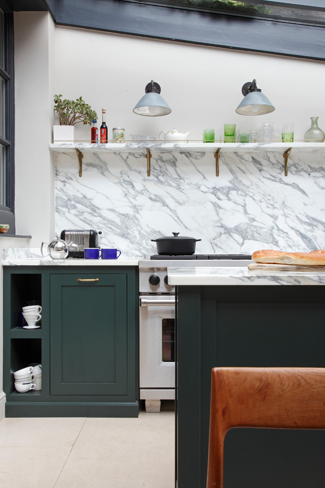 Inspiration for an eclectic galley eat-in kitchen in London with a drop-in sink, shaker cabinets, green cabinets, marble benchtops, marble splashback, stainless steel appliances, limestone floors and with island.
