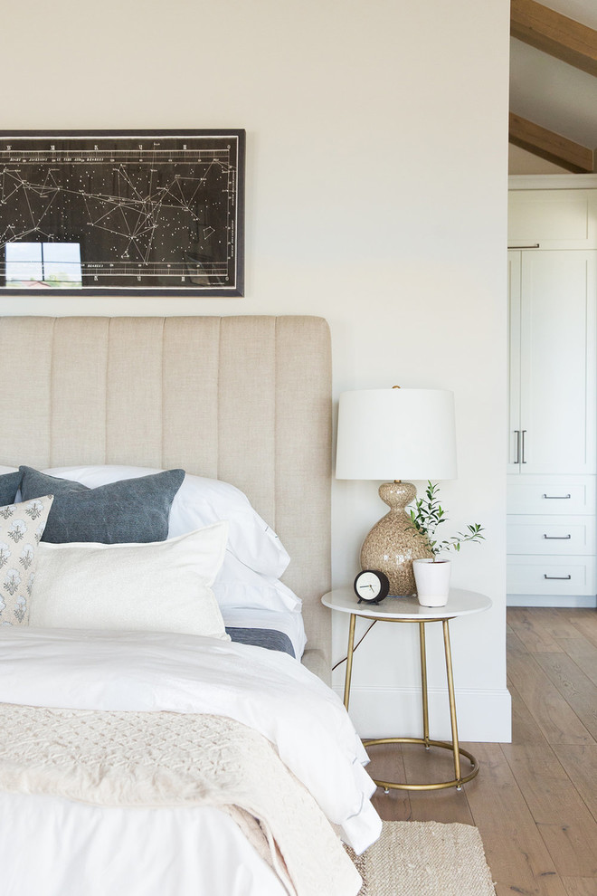 Inspiration for a large country master bedroom in Salt Lake City with white walls and dark hardwood floors.