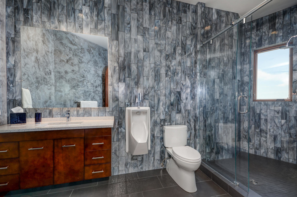 Mid-sized contemporary 3/4 bathroom in Tampa with flat-panel cabinets, medium wood cabinets, an alcove shower, a two-piece toilet, gray tile, glass tile, grey walls, porcelain floors, an undermount sink and terrazzo benchtops.