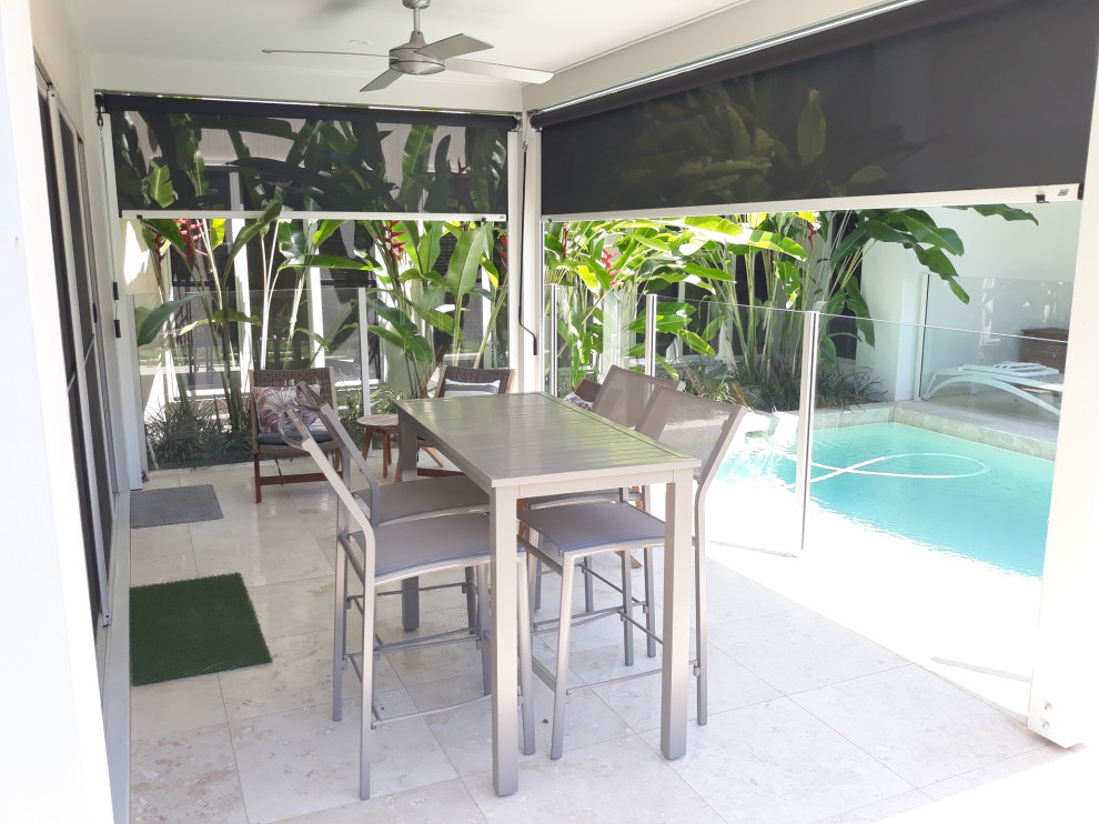 This is an example of a mid-sized contemporary backyard patio in Sunshine Coast with an awning.