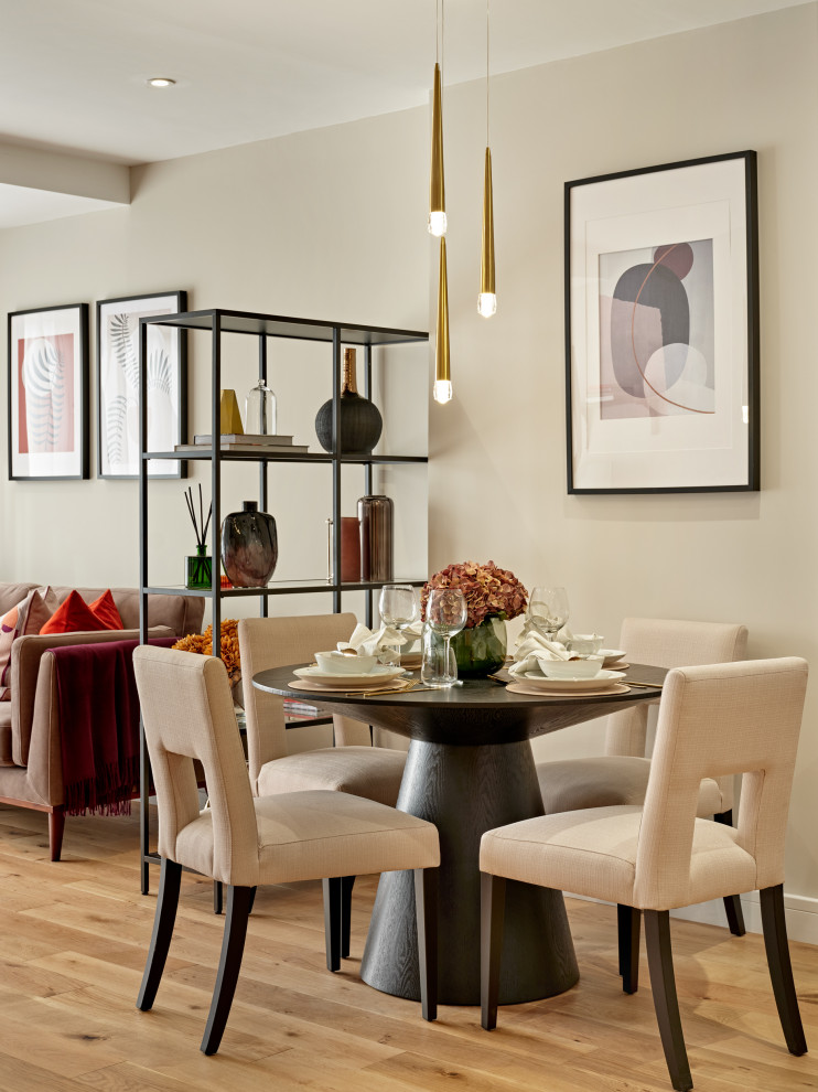 Medium sized contemporary dining room in London with beige walls, medium hardwood flooring and no fireplace.