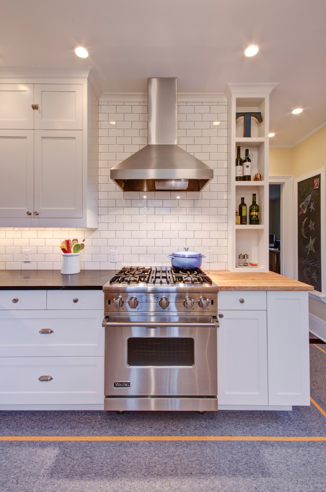Kitchen in Portland with recessed-panel cabinets, white cabinets, soapstone benchtops, white splashback, subway tile splashback, stainless steel appliances and linoleum floors.