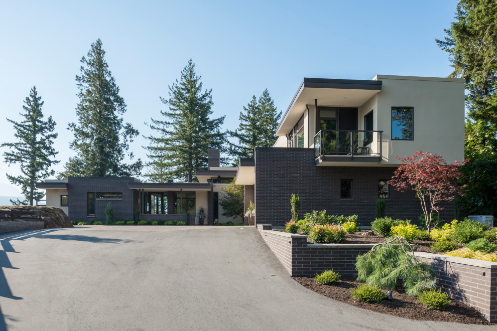 Contemporary two-storey brick house exterior in Vancouver with a flat roof.