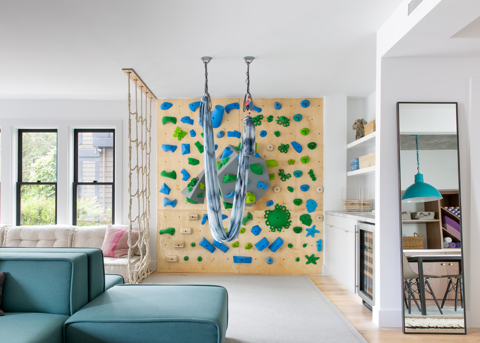 Pacific Heights Collected Contemporary - Intentional. Elevated. Artisanal.
 
With three children under the age of 5, our clients were starting to feel the confines of their Pacific Heights home when the expansive 1902 Italianate across the street went on the market. After learning the home had been recently remodeled, they jumped at the chance to purchase a move-in ready property. We worked with them to infuse the already refined, elegant living areas with subtle edginess and handcrafted details, and also helped them reimagine unused space to delight their little ones.
 
Elevated furnishings on the main floor complement the home’s existing high ceilings, modern brass bannisters and extensive walnut cabinetry. In the living room, sumptuous emerald upholstery on a velvet side chair balances the deep wood tones of the existing baby grand. Minimally and intentionally accessorized, the room feels formal but still retains a sharp edge—on the walls moody portraiture gets irreverent with a bold paint stroke, and on the the etagere, jagged crystals and metallic sculpture feel rugged and unapologetic. Throughout the main floor handcrafted, textured notes are everywhere—a nubby jute rug underlies inviting sofas in the family room and a half-moon mirror in the living room mixes geometric lines with flax-colored fringe. 
 
On the home’s lower level, we repurposed an unused wine cellar into a well-stocked craft room, with a custom chalkboard, art-display area and thoughtful storage. In the adjoining space, we installed a custom climbing wall and filled the balance of the room with low sofas, plush area rugs, poufs and storage baskets, creating the perfect space for active play or a quiet reading session. The bold colors and playful attitudes apparent in these spaces are echoed upstairs in each of the children’s imaginative bedrooms.
 
Architect + Developer: McMahon Architects + Studio, Photographer: Suzanna Scott Photography
