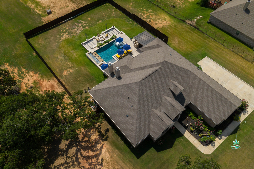 Huge tuscan backyard custom-shaped infinity pool landscaping photo in Dallas with decking