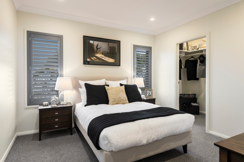 Mid-sized contemporary guest bedroom in Brisbane with beige walls and carpet.