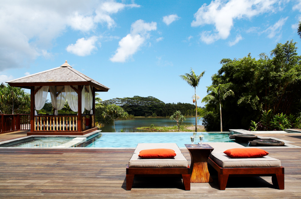 Inspiration for an expansive tropical rectangular pool in Hawaii with decking.