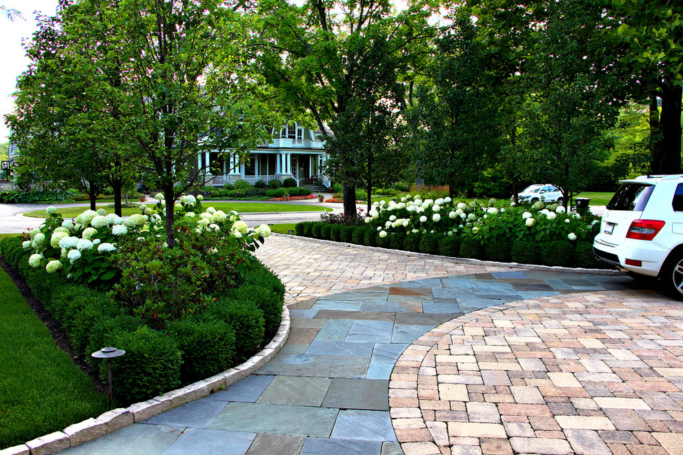 This is an example of a traditional front yard driveway in Chicago with brick pavers.